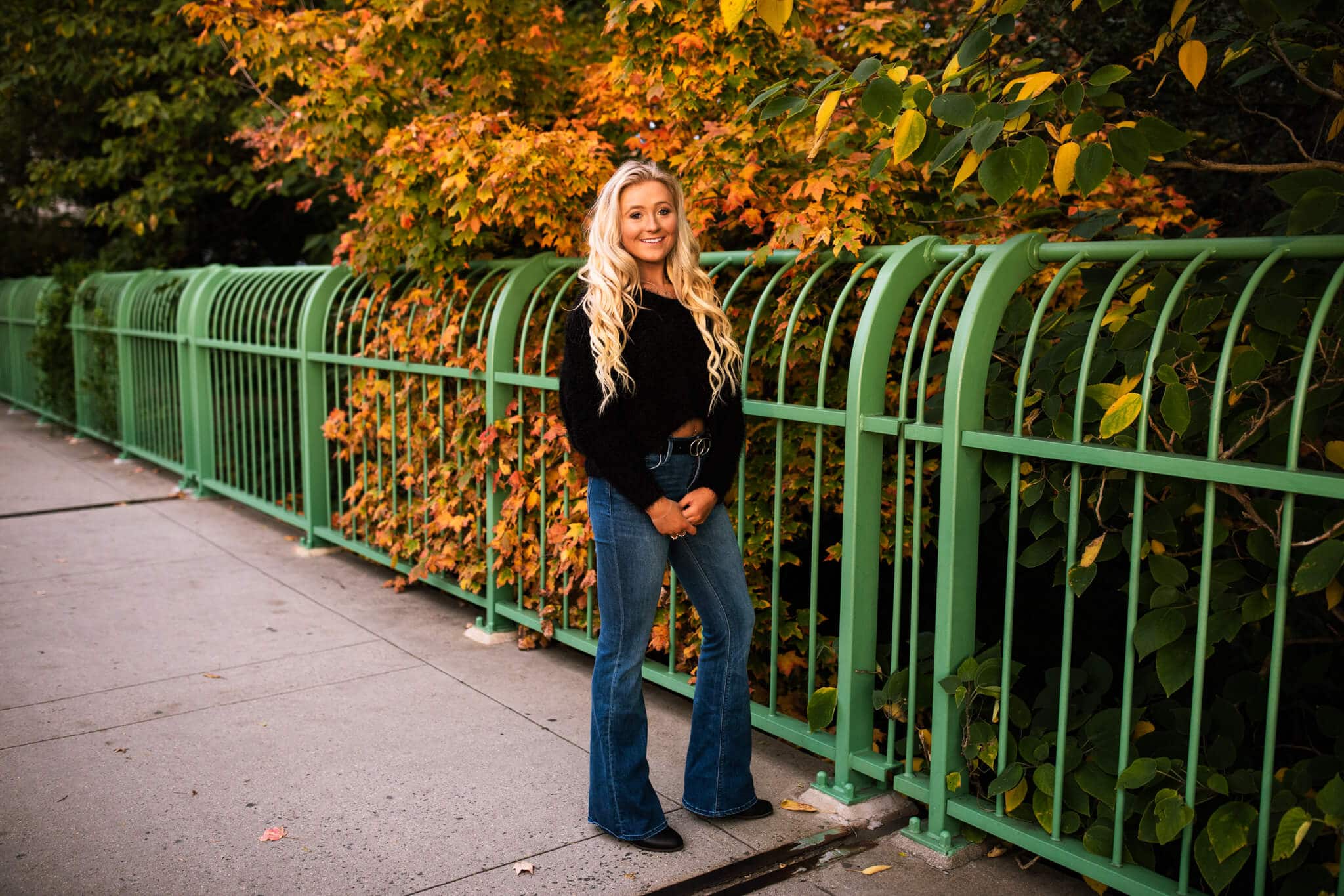high school senior girl in front of fall foilage