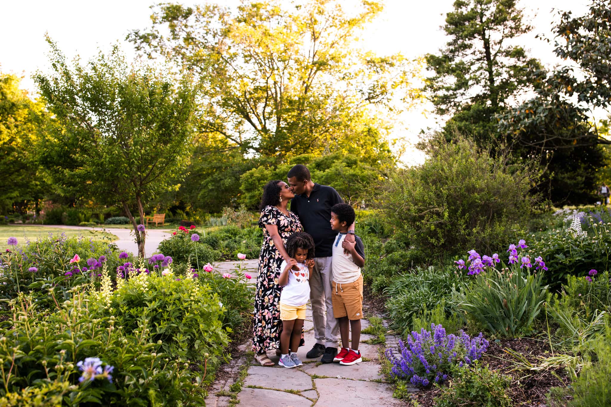 family standing on garden path hugging