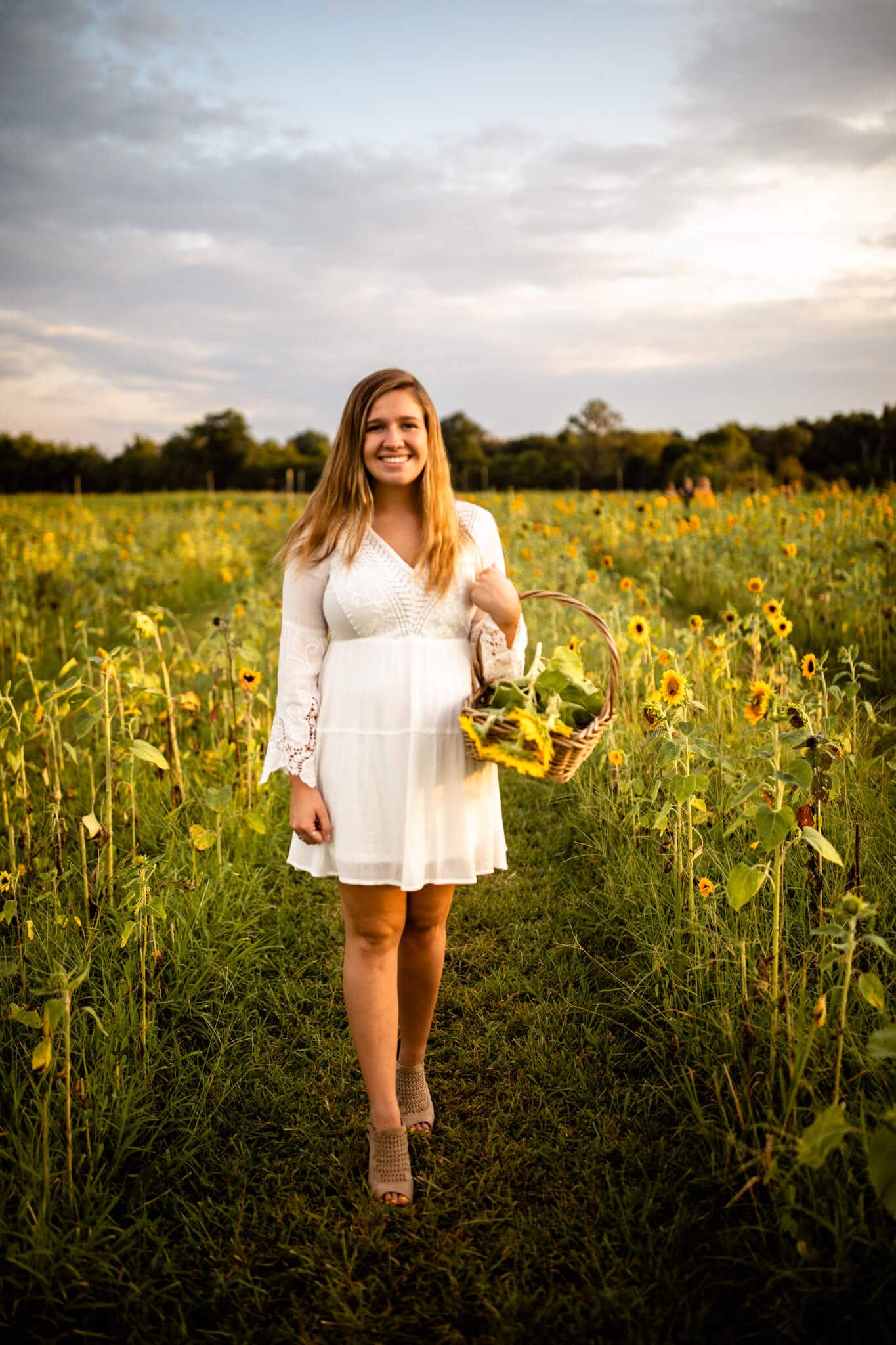 high school senior girl in sunflower field