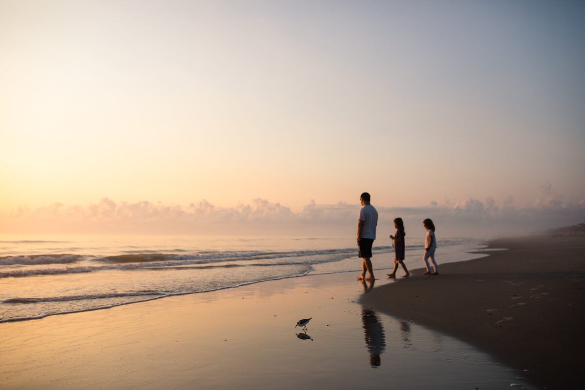 dad with 2 kids on beach at sunrise