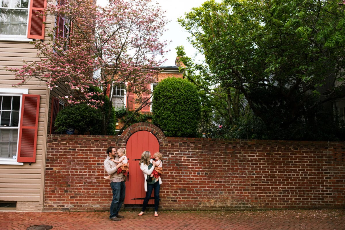 family in old town Alexandria under blooming dogwood tree