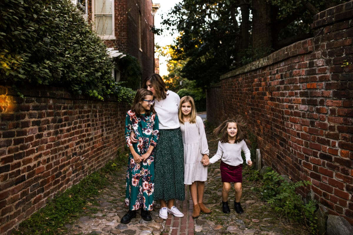 mother with 3 daughters in brick alley