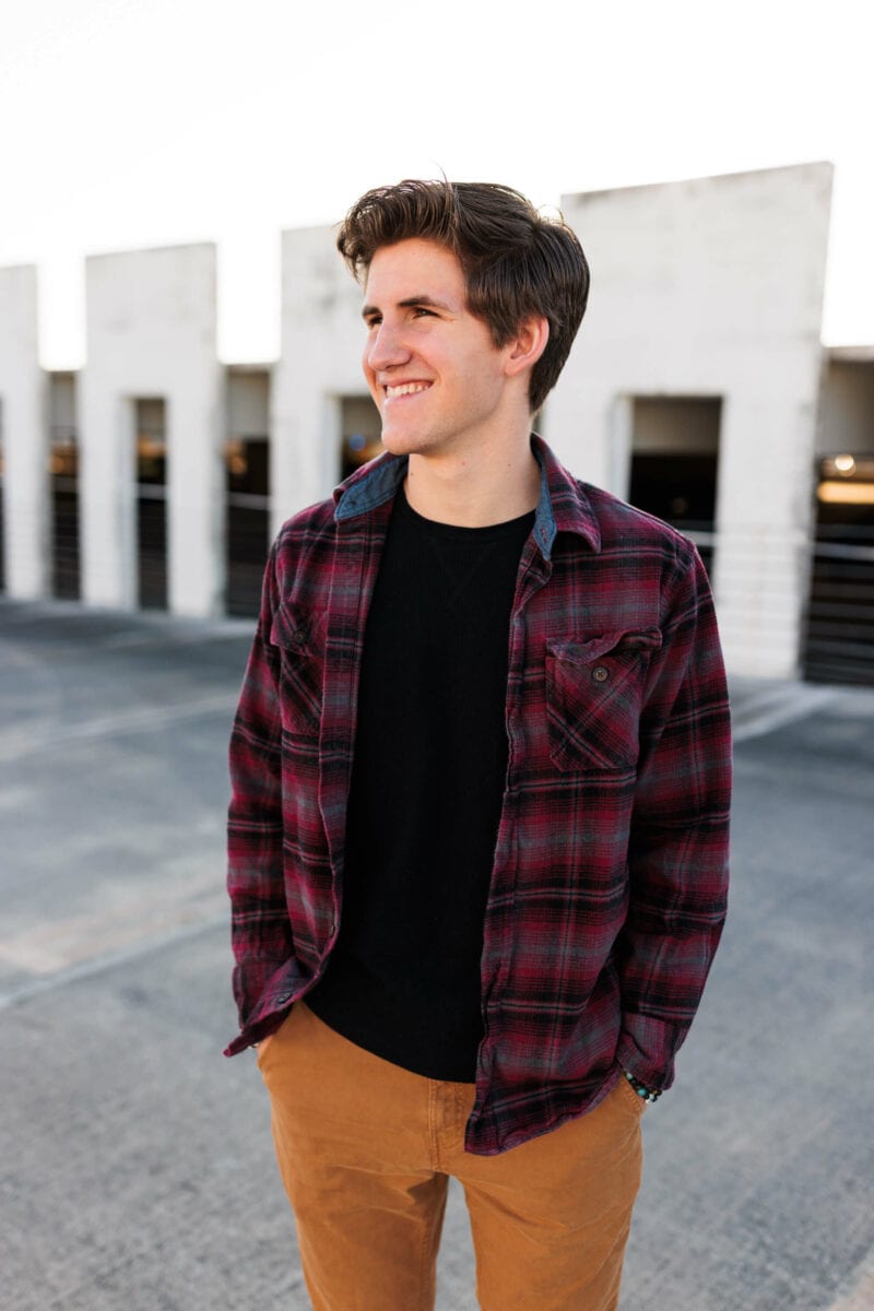 boy looking off camera in image showing inspiration for a parking garage senior session
