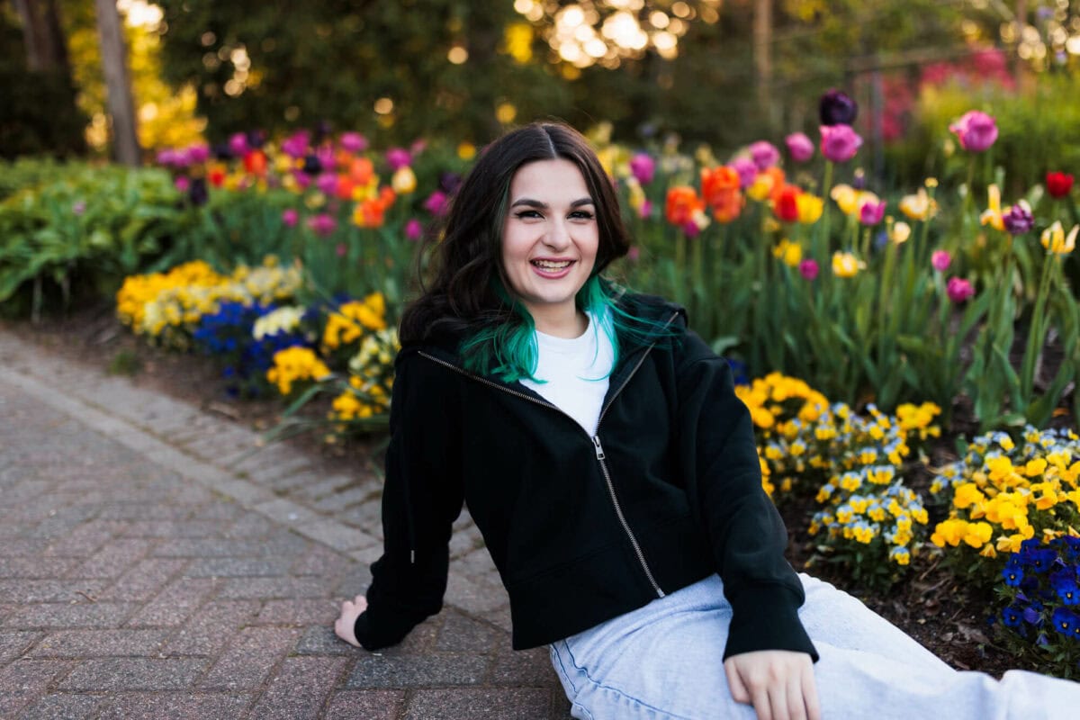 high school senior girl in garden smiling