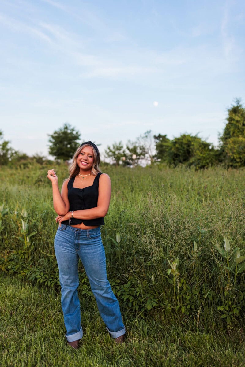 high school senior girl standing in field