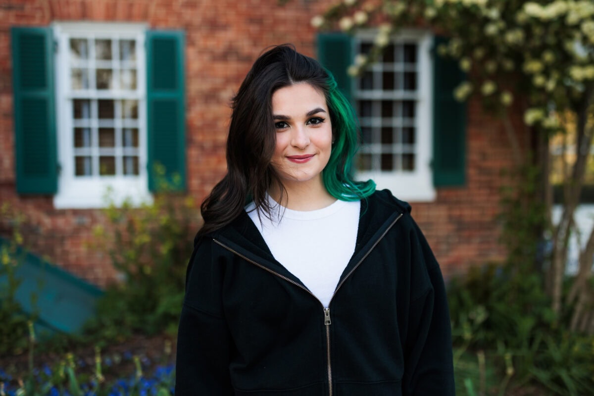 spring senior session with girl in garden and historic house