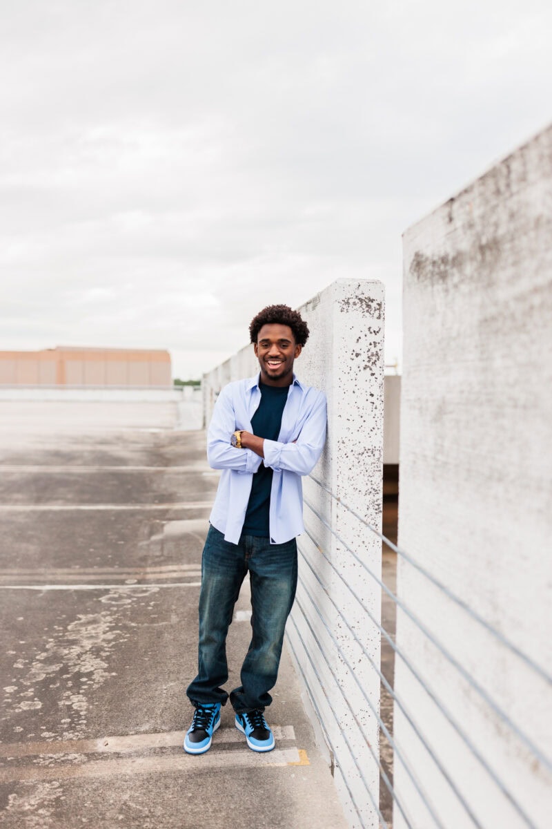 senior boy for Washington DC area session photography on rooftop garage