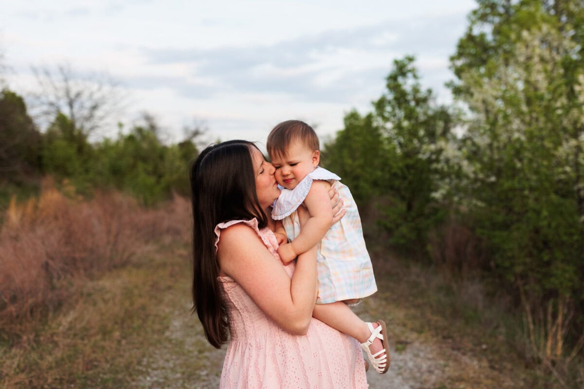 mother daughter snuggling outdoors at photo maternity session northern Virginia 